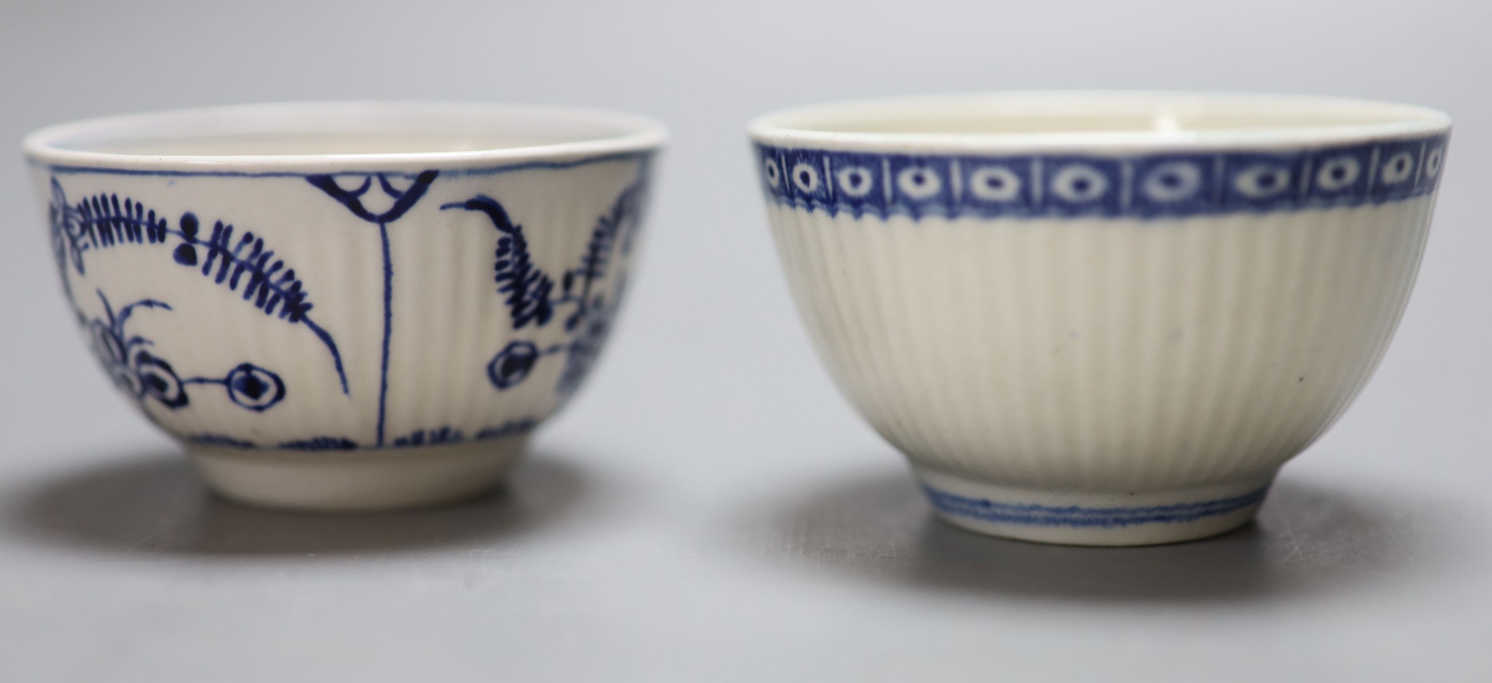 An 18th century Worcester reed moulded teabowl and saucer Immortelle pattern and another painted with Dark Sprig Centre, all but one ma